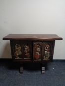 An stained pine carved double door cabinet depicting knights