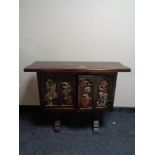 An stained pine carved double door cabinet depicting knights