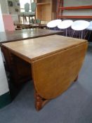 A blond oak gate leg table