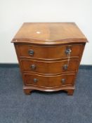 A serpentine fronted three drawer chest