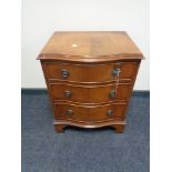 A serpentine fronted three drawer chest