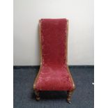 A 19th century mahogany nursing chair in red floral fabric