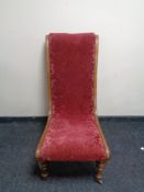 A 19th century mahogany nursing chair in red floral fabric