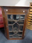 An Edwardian stained pine corner cabinet