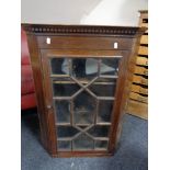 An Edwardian stained pine corner cabinet