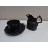 Four pieces of black Wedgwood Jasper ware, tea cup, saucer,