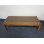 A rectangular glass topped coffee table,