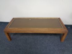 A rectangular glass topped coffee table,