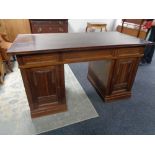 An early 20th century twin pedestal writing desk