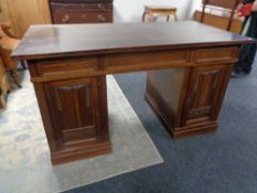 An early 20th century twin pedestal writing desk