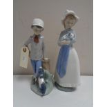 Two Nao figures - Boy with dog,