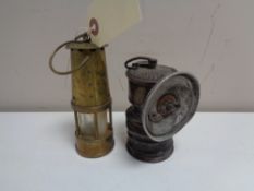 A vintage premiere carbide lamp together with a miniature brass Eccles protector miner's lamp