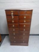 A late Victorian mahogany fourteen-drawer index chest.