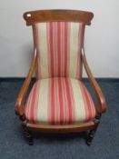 An early 20th century armchair upholstered in a striped fabric