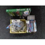 A box of Playstation 3 and Xbox 360 games, mobile phones,