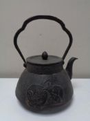An antique Oriental style cast iron kettle with rat decoration