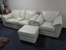 A Violino cream leather two seater settee with central arm rests and cup holders,
