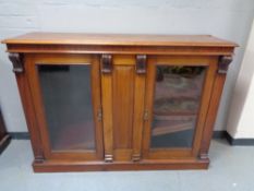 A Victorian mahogany glazed double door bookcase