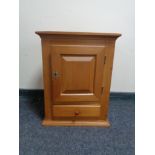 An oak wall cabinet fitted a drawer