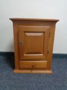 An oak wall cabinet fitted a drawer