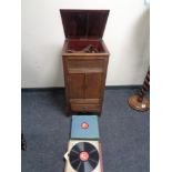 An early twentieth century oak gramophone in oak cabinet together with 78's