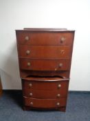 A pair of bow-fronted three drawer chests in walnut finish