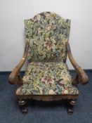 A 20th century carved oak scroll arm armchair