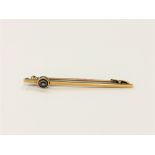 A 15ct gold bar brooch set with a blue gem stone CONDITION REPORT: 2.