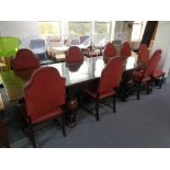 An early 20th century dining table with eight high back chairs