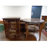 A circular mid 20th century table and a nest of three walnut tables