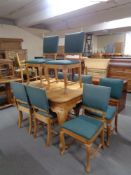 An early 20th century oak dining table on cabriole legs together with a set of eight matching