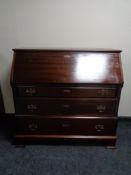 A 20th century mahogany bureau with brass drop handles