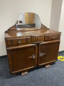 A 20th century oak mirror backed sideboard