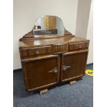 A 20th century oak mirror backed sideboard