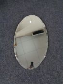 An oval frameless mirror