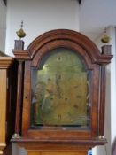 An antique oak and mahogany longcase clock by Burnett with pendulum and weights