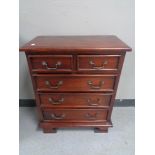 A reproduction mahogany five drawer chest