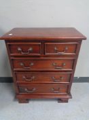 A reproduction mahogany five drawer chest