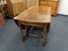 A Victorian oak gate leg table