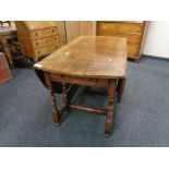 A Victorian oak gate leg table