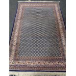 A Persian woolen rug on blue ground