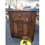 An oak effect corner cupboard