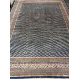 A Persian woolen carpet on blue ground