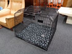 A folding black metal dog cage,