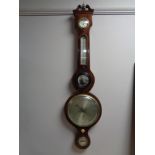 A late 19th century inlaid mahogany banjo barometer, with silvered dial,