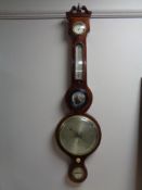 A late 19th century inlaid mahogany banjo barometer, with silvered dial,