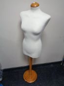 A dress makers mannequin on pine stand