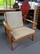 A mid 20th century teak framed armchair