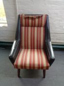 A mid 20th century Danish armchair in black vinyl