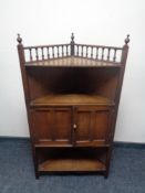 An Edwardian oak double door corner stand